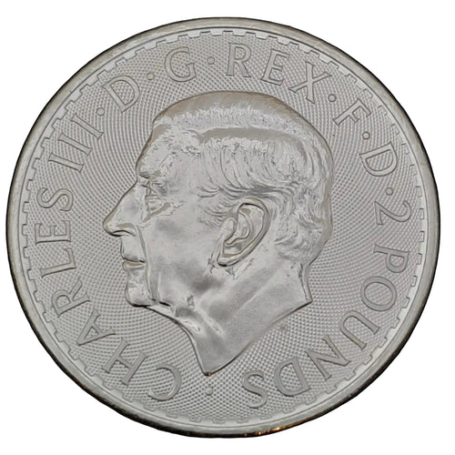 Silver coin with a king charles portrait on a black background